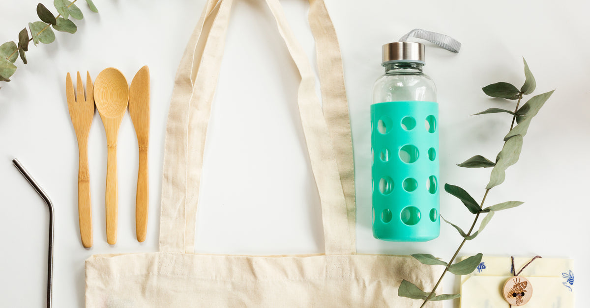 Des sacs en filet de marque privée et une trousse de courses réutilisable sur une table blanche